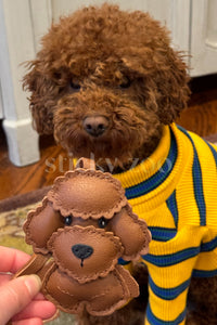 Close-up of handmade Poodle leather bag charm — hand-layered droopy ears in French Alran goatskin. STICKYZOO.