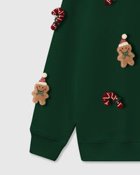 Extreme close-up of plush candy cane and gingerbread character showing dimensional depth on forest green