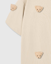 Detail of sleeve and body on STICKYZOO beige Bear T-Shirt showing plush bear faces at different angles