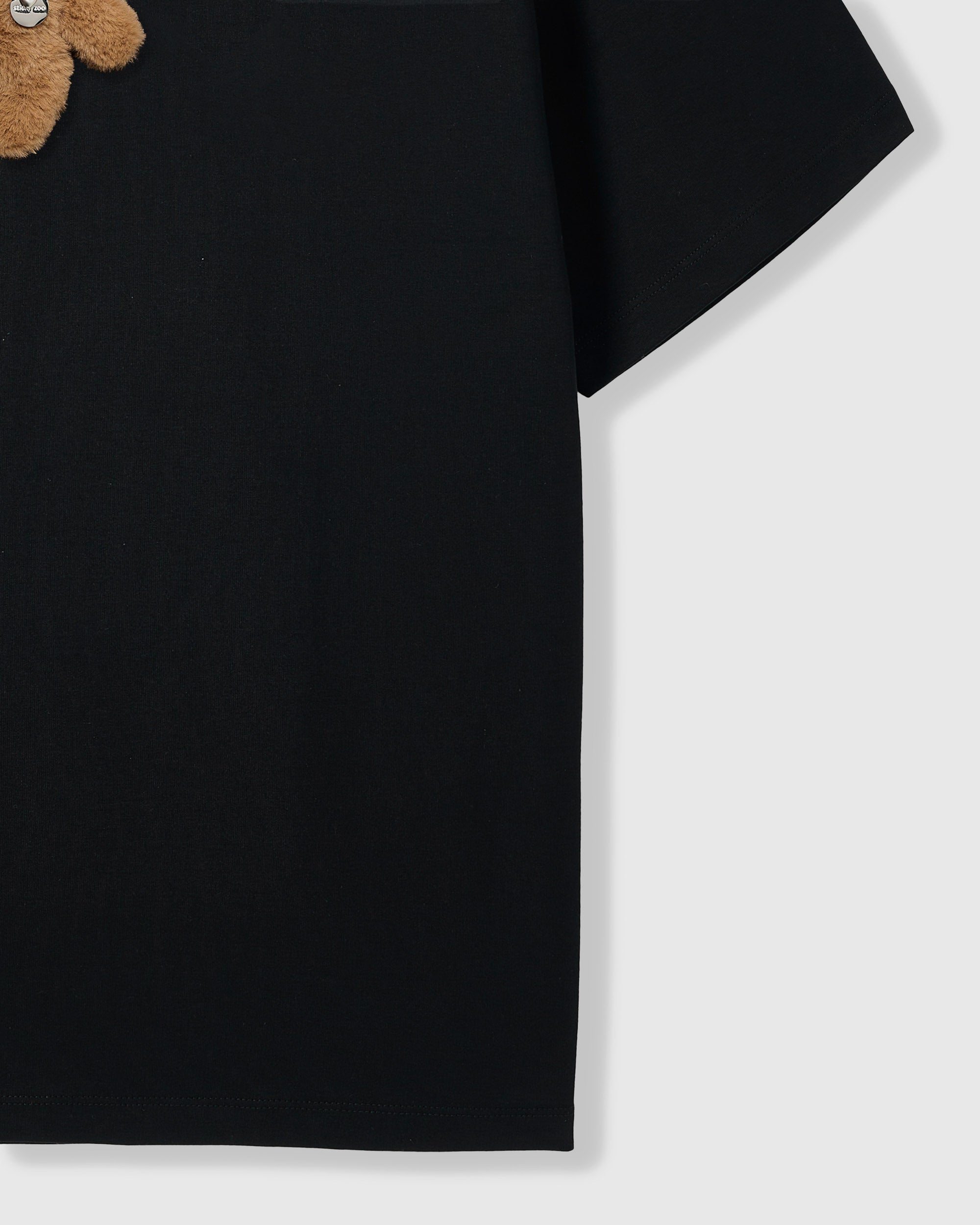 Side view of Hug-Me Bear T-Shirt in black showing sleeve and cotton fabric