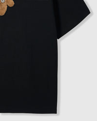 Side view of Hug-Me Bear T-Shirt in black showing sleeve and cotton fabric