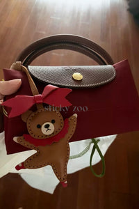 BALLET BEAR CHARM charm styled on a bag — a small, specific piece that turns a simple bag into a personal one.