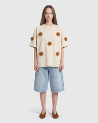 Model in cream Poodle Parade T-Shirt front view showing all seven plush poodle appliques