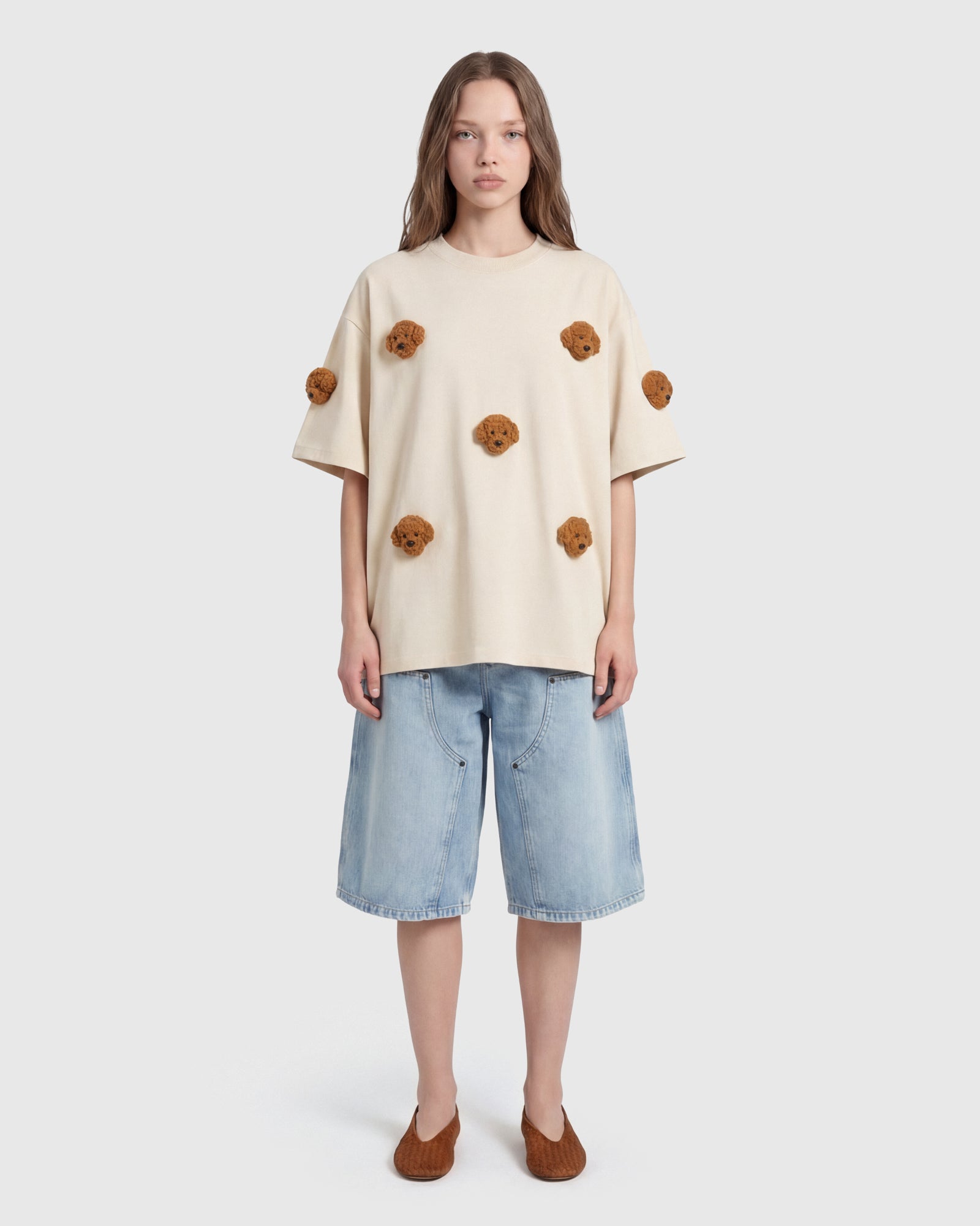 Model in cream Poodle Parade T-Shirt front view showing all seven plush poodle appliques