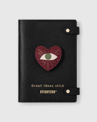 STICKYZOO Evil Eye Heart Talisman Notebook with hand-cut French Alran leather charm on black genuine goatskin cover, gold snap closure