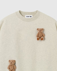 Close-up of dual plush teddy bear appliques on light gray 450gsm cotton fleece showing 3D texture
