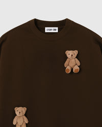 Close-up of dual plush teddy bears on dark brown 450gsm cotton fleece showing tonal 3D detail