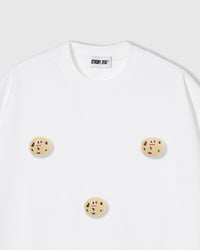 Close-up of plush cookie appliques on white 230gsm cotton showing smiling faces and chocolate chip texture