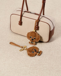 both brown poodle charm editions styled with bag — handmade French Alran goatskin, alcantara suede, 72 hours per piece.