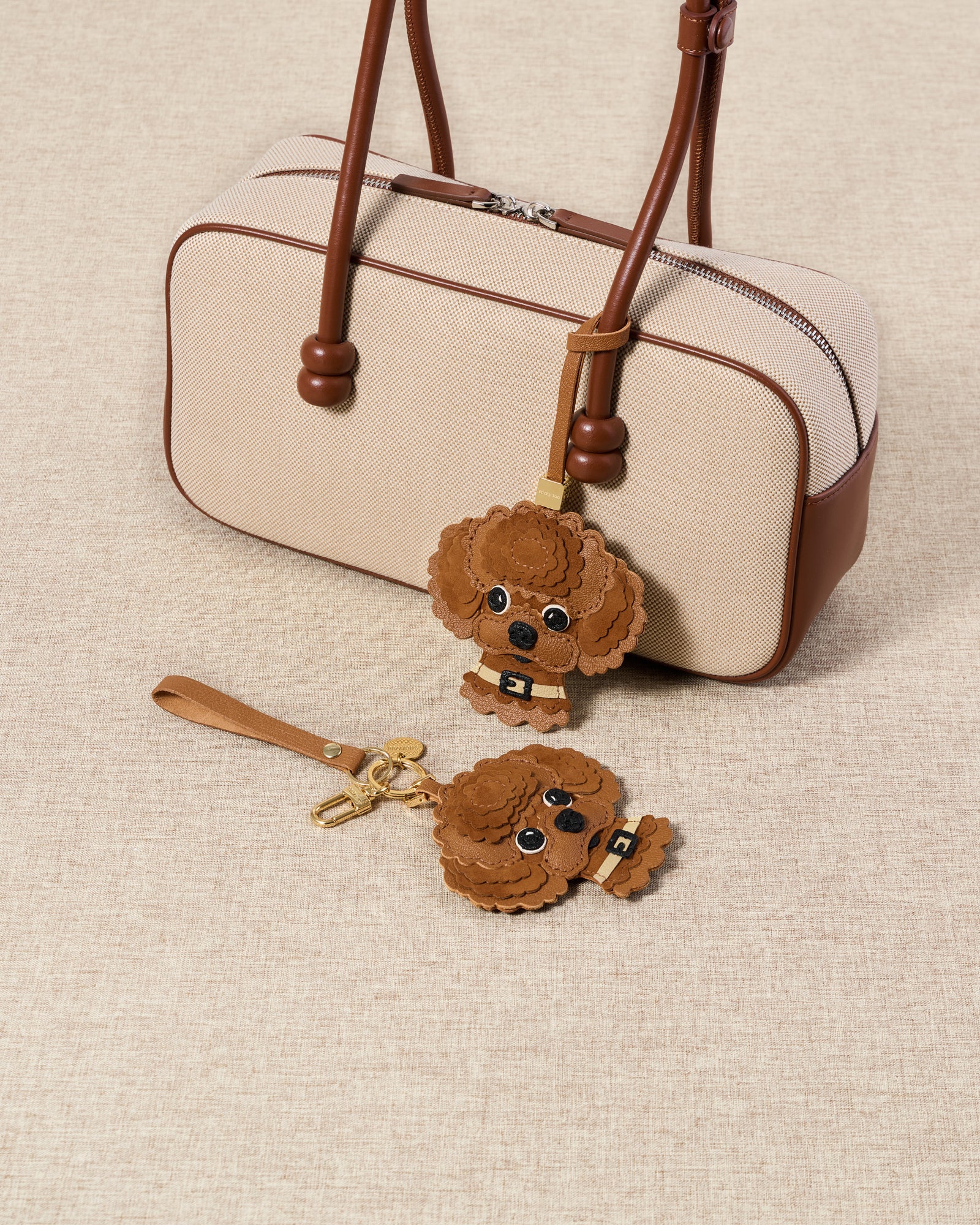 {{Hand-cut. Hand-stitched.}} Tight detail of The Poodle — scalloped Alcantara curls in warm cognac layered over French Alran goatskin, gold collar with hand-cut buckle.