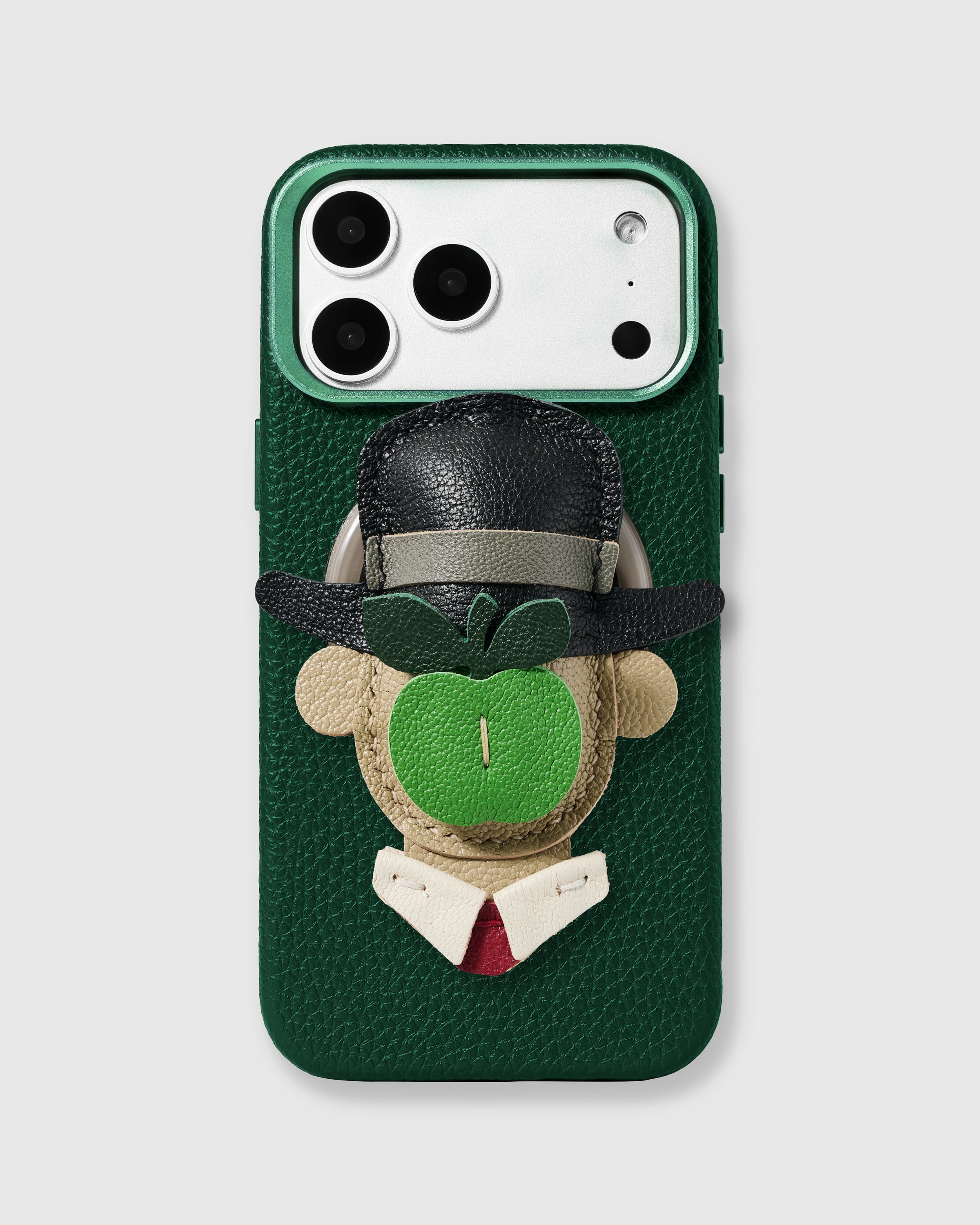 {{Handmade Magritte charm.}} STICKYZOO The Son of Man Charm Case with 3D handmade French Alran leather charm featuring bowler hat and green apple on green pebbled leather case