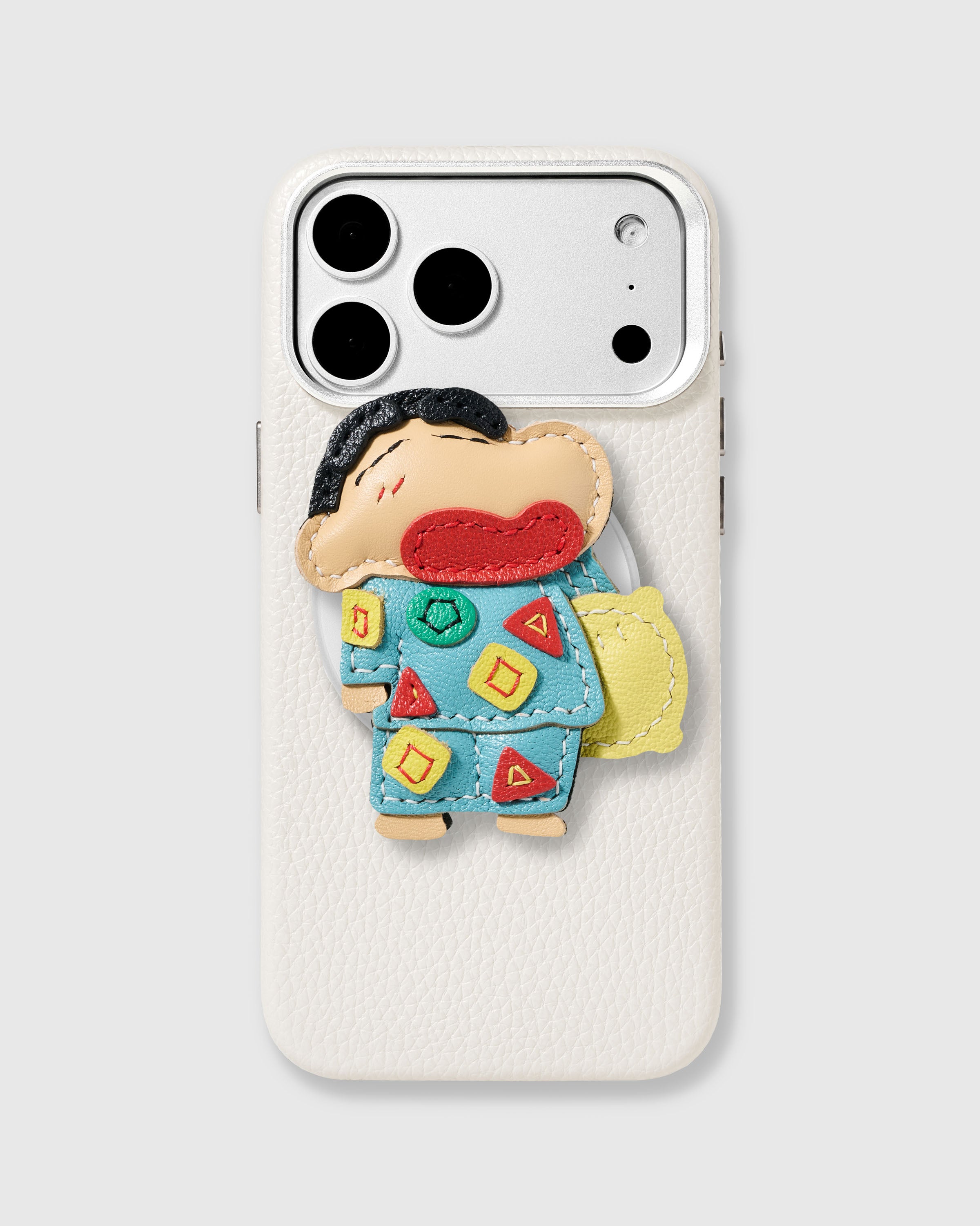 Shin-Chan leather charm on case.