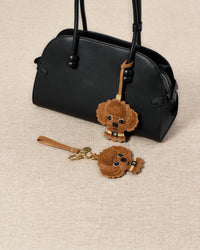 both editions styled with bag — French Alran leather, alcantara suede, 18K gold-plated hardware.