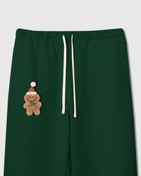 Close-up of plush gingerbread man applique with Santa hat on forest green heavyweight fleece showing 3D texture