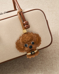 on bag — the face that makes strangers stop. French Alran leather scalloped curls, 72 hours by hand.