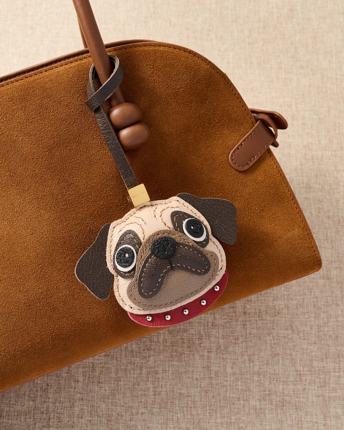 {{The exclusive drop.}} The Pug Charm — exclusive drop from STICKYZOO. Designed in Amsterdam. French Alran goatskin. Not restocked once sold out.