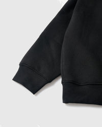 Close-up of ribbed cuff and hem showing premium cotton construction