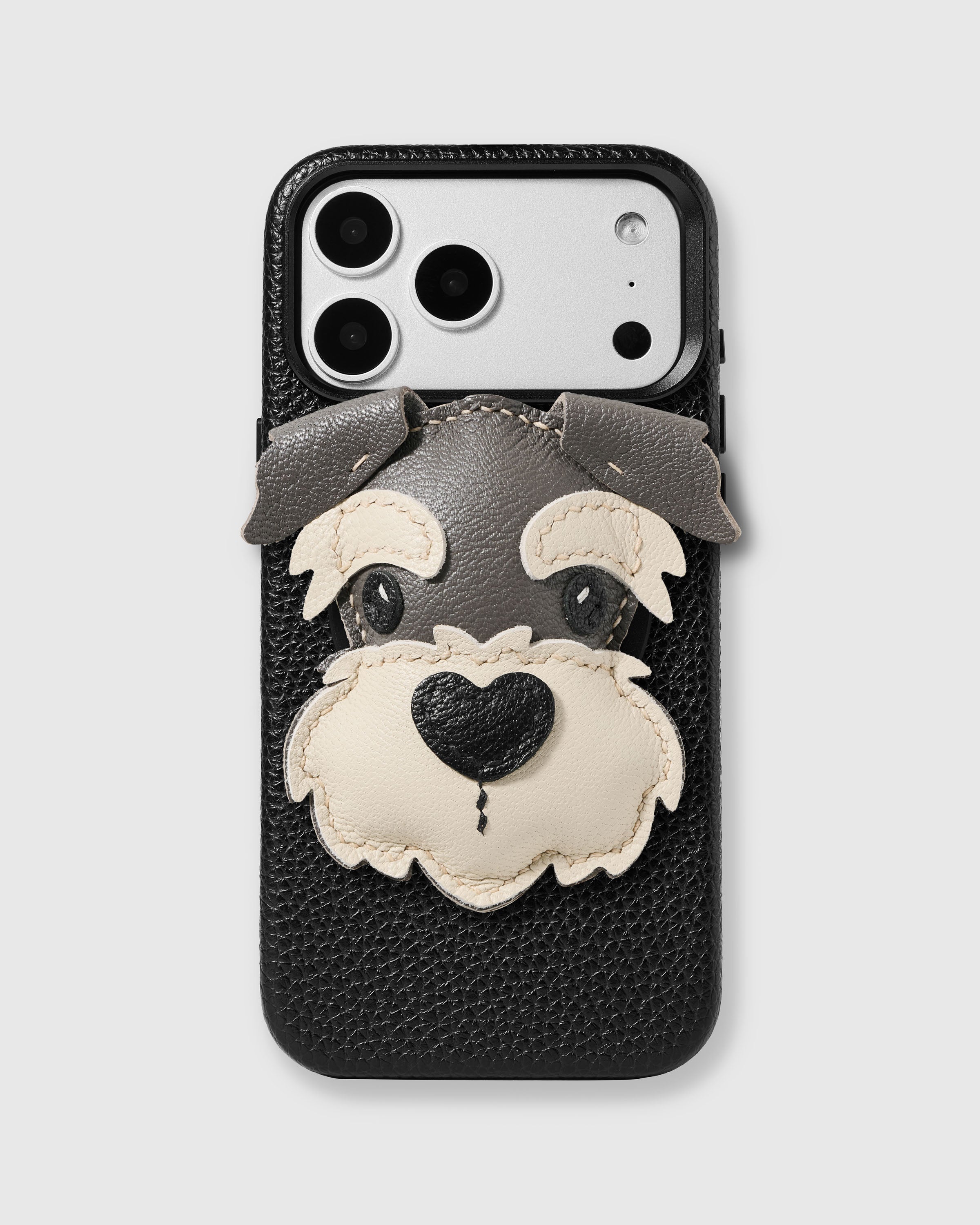 STICKYZOO Schnauzer Charm Case in black with 3D handmade French Alran leather schnauzer charm featuring grey and cream layered ears, beard, and heart-shaped nose.