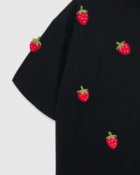 Detail of plush strawberry appliques near shoulder on STICKYZOO Strawberry T-Shirt in black