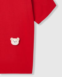 Model wearing Teddy Check-Ear T-Shirt in red showing dropped shoulders