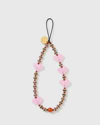 STICKYZOO Hazel Heart phone strap laid flat: translucent pink jelly hearts, striped brown-and-cream barrel beads and rust-brown rounds on a black cord loop