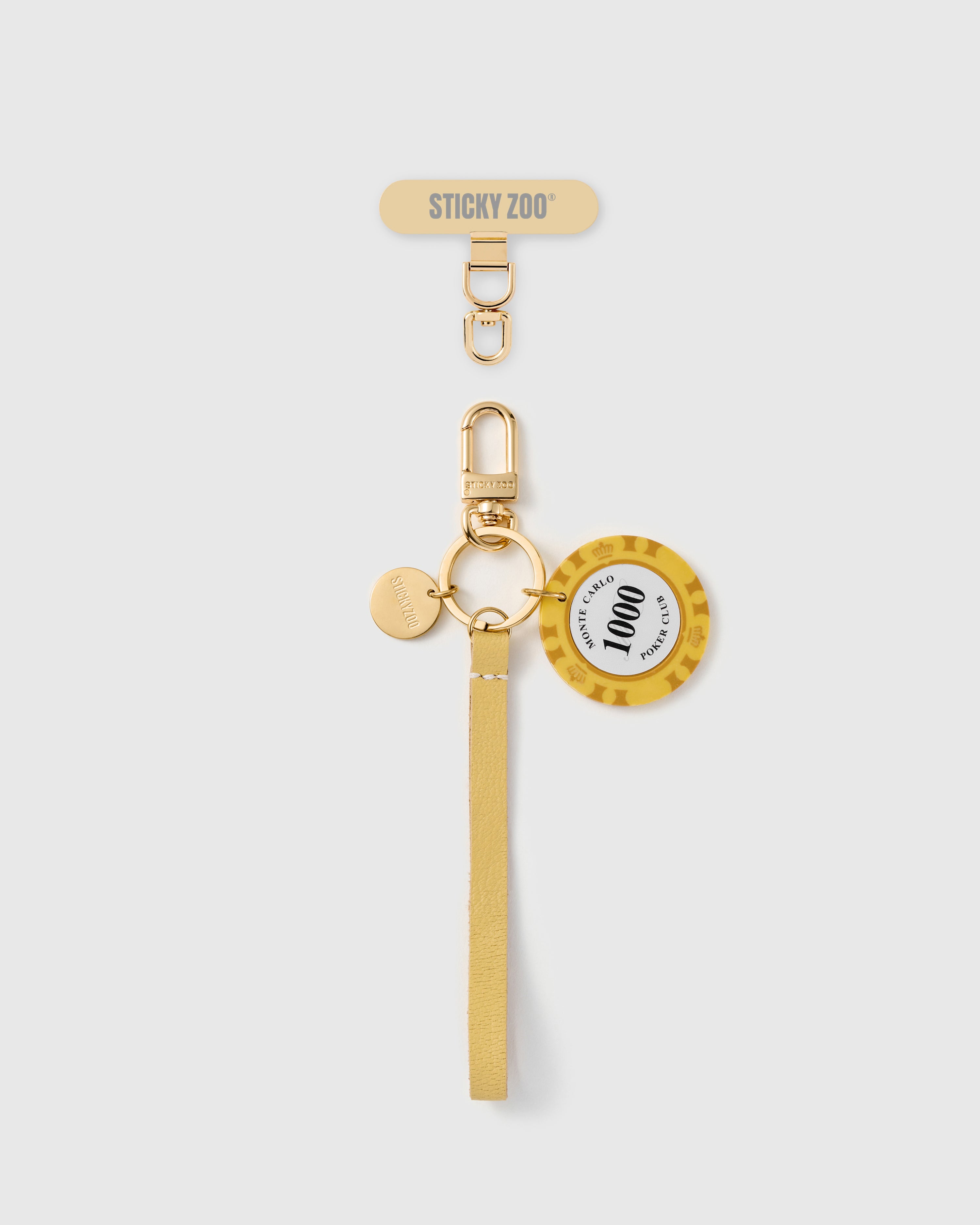 Handmade French Alran saffron yellow leather phone strap with vintage-style translucent yellow chip charm and 18K gold STICKYZOO hardware