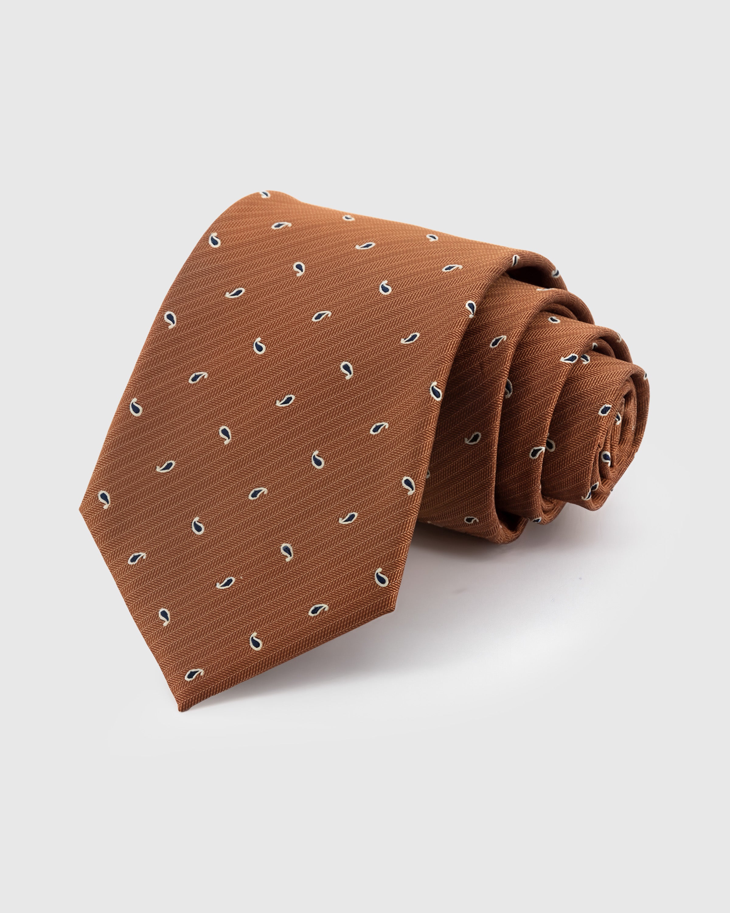 STICKYZOO Terracotta Paisley Drop Tie in hand-embroidered mulberry silk with scattered navy paisley drops, 45° bias-cut Italian method