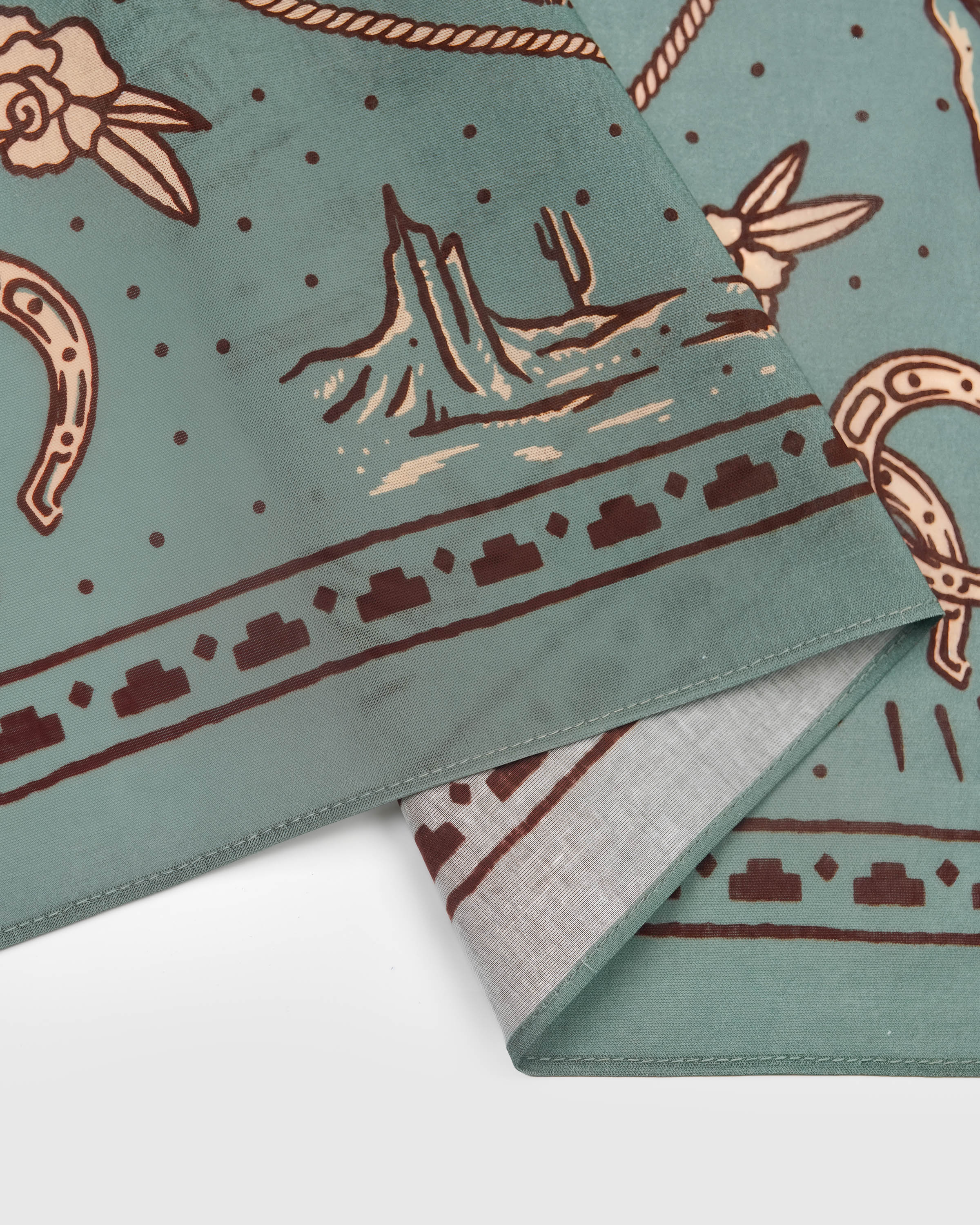 Dotted bandana border on the sage silk scarf showing the deep brown ink and the printed edge
