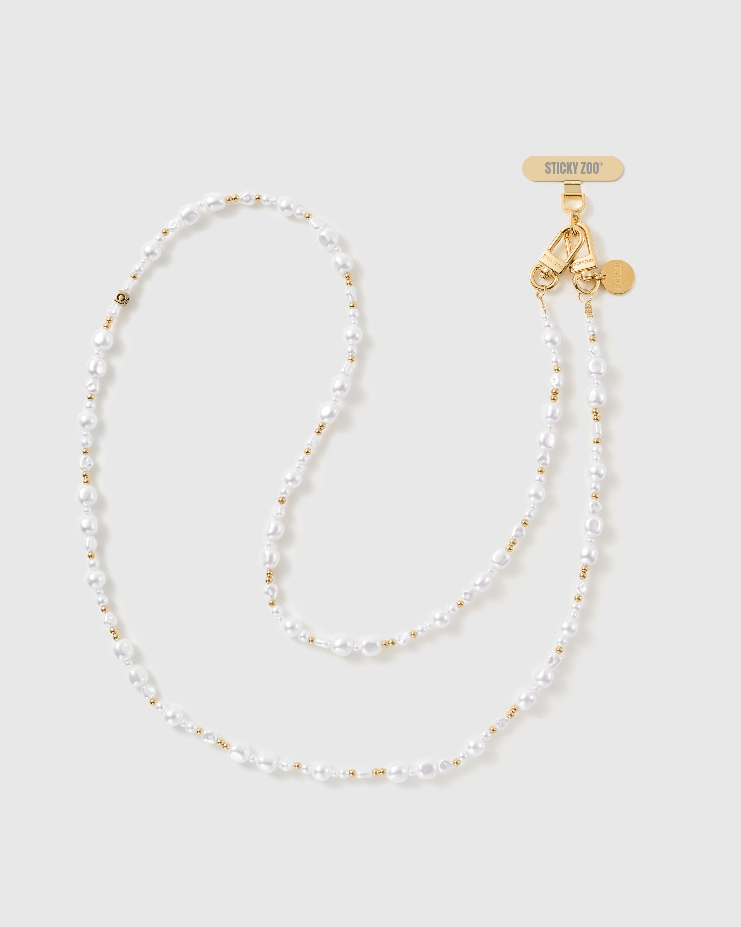 Full-length STICKYZOO crossbody phone strap of white baroque faux-pearls and gold-tone ball beads, with gold dual clasps and engraved disc.