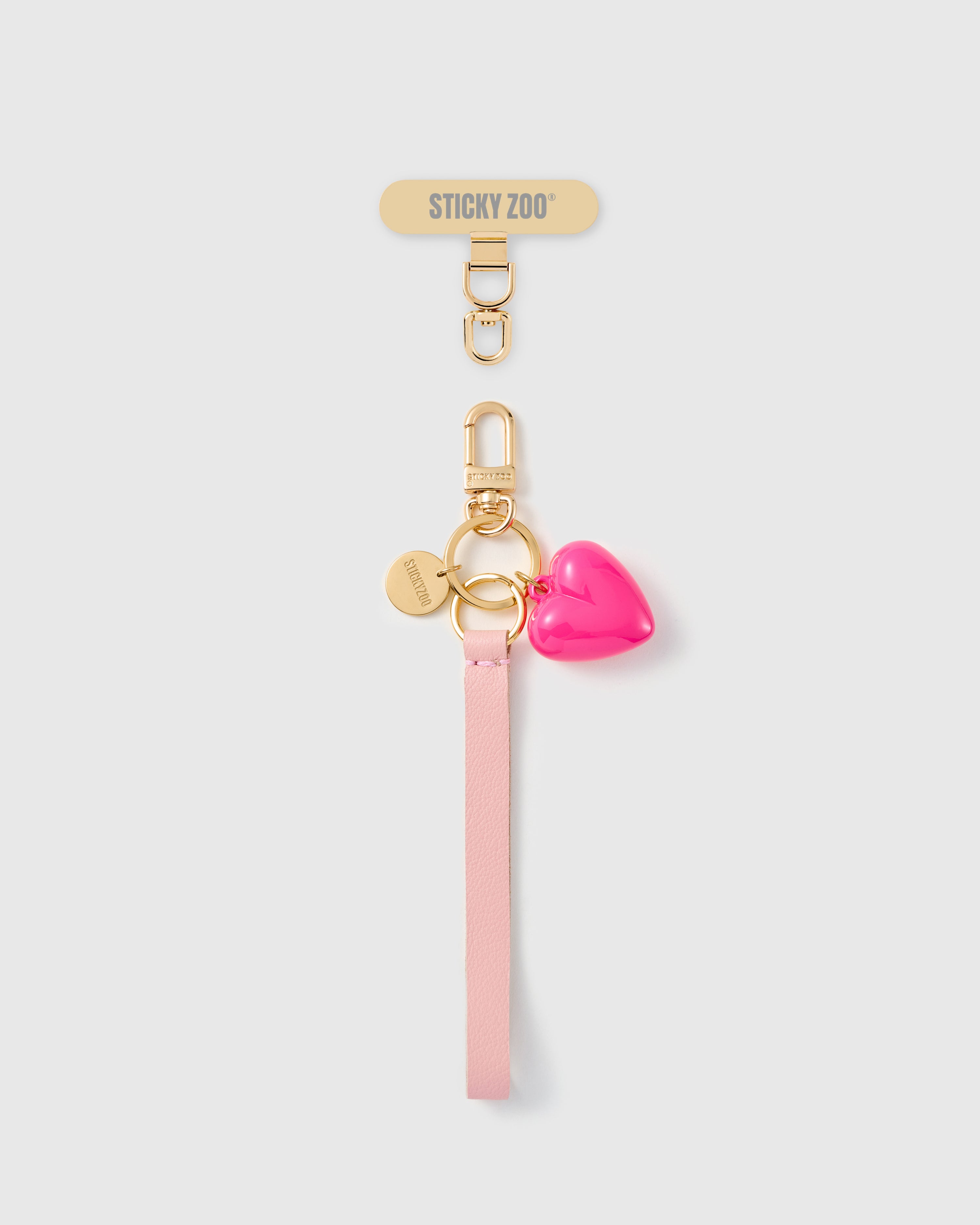 Handmade French Alran pale pink leather phone strap with glossy hot pink puff heart charm and 18K gold STICKYZOO hardware