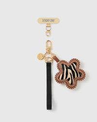 STICKYZOO noir zebra bloom leather phone strap, zebra calf-hair flower charm on a black leather strap with gold hardware