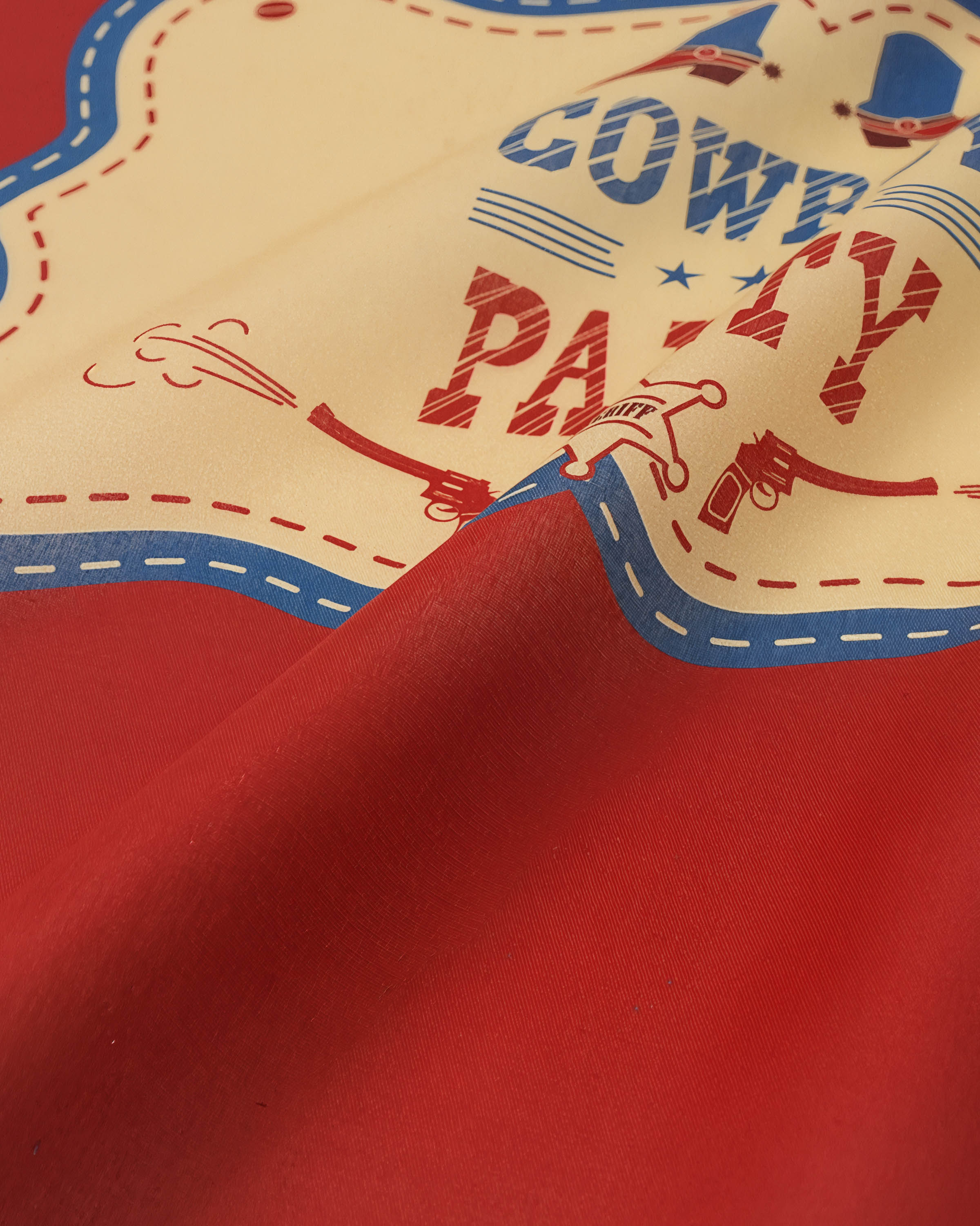 Close-up of the ivory paisley corner on the silk scarf showing the inked detail and stitched hem
```