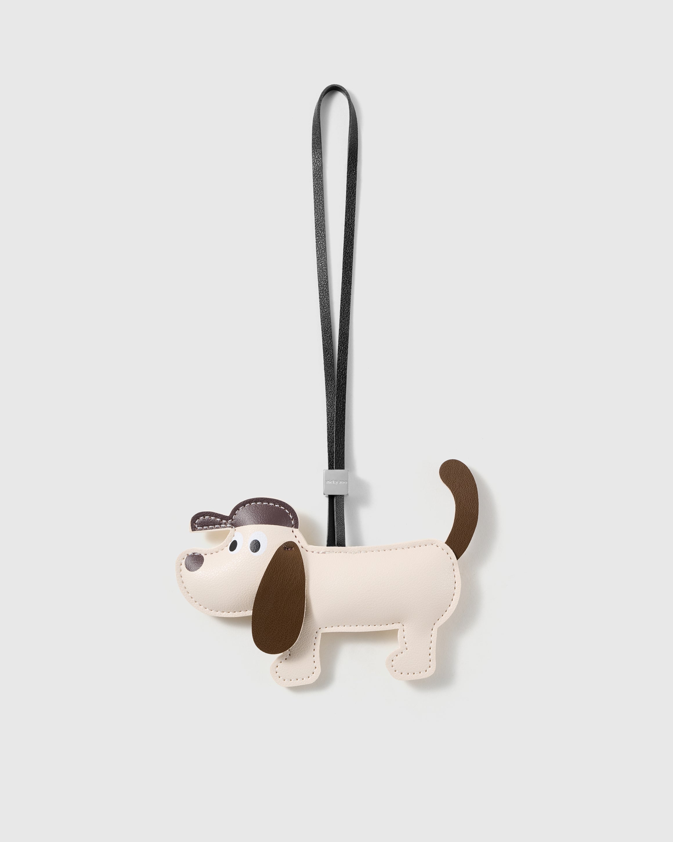 Handmade two-tone French Alran leather puppy bag charm with engraved 18K gold-plated hardware by STICKYZOO