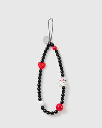 STICKYZOO Dalmatian phone strap laid flat: glossy black beads, a red glossy heart, a dalmatian puppy charm, two red beads, a white bead, silver disc.