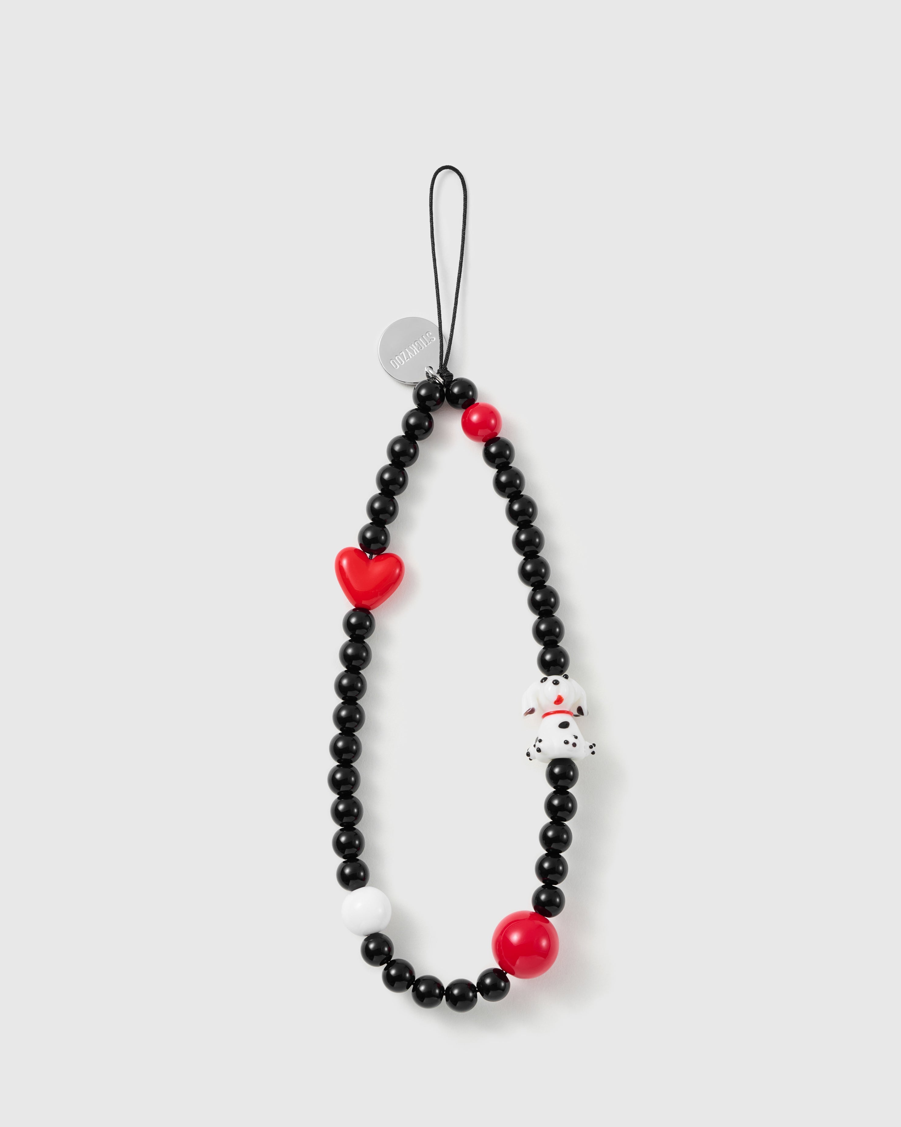 STICKYZOO Dalmatian phone strap laid flat: glossy black beads, a red glossy heart, a dalmatian puppy charm, two red beads, a white bead, silver disc.