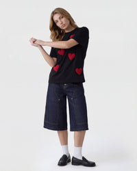 Model wearing Scattered Heart T-Shirt in black showing relaxed oversized fit