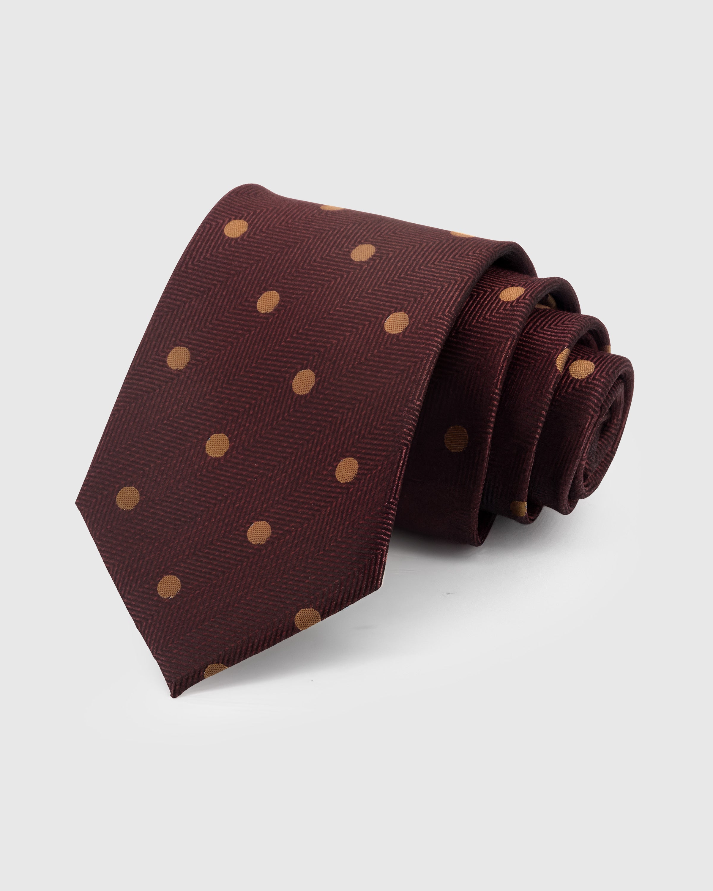 MERLOT POLKA TIE — Hand-embroidered polka dot detail on 100% mulberry silk in merlot, showing embroidery texture and silk sheen