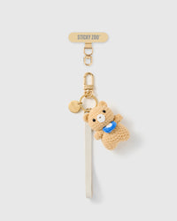 Handmade French Alran ivory leather phone strap with hand-crochet camel teddy and blue scarf charm, 18K gold STICKYZOO hardware