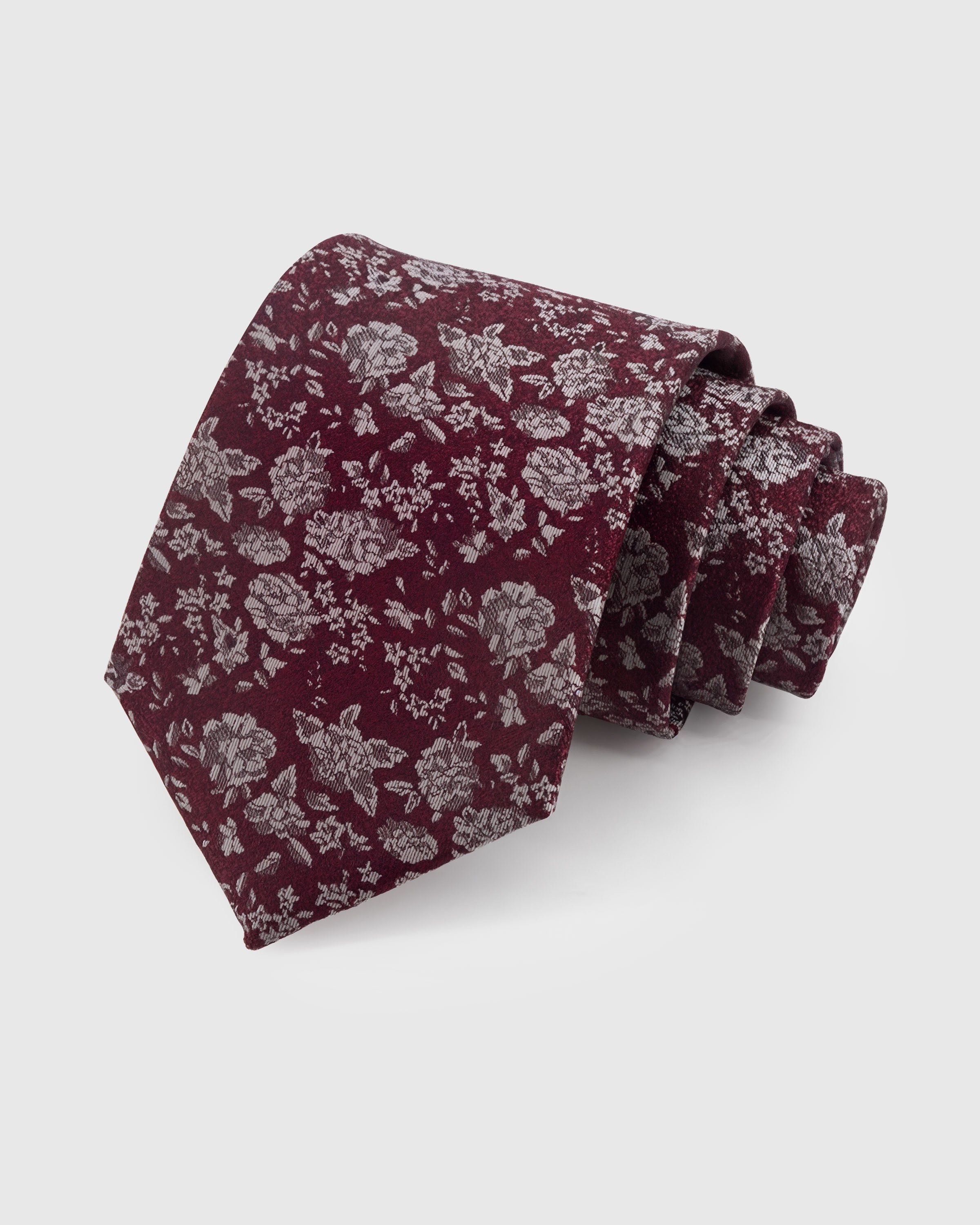 STICKYZOO WINE DITSY TIE — 100% mulberry silk with hand-embroidered silver-tone scattered ditsy floral and leaf motifs on rich wine burgundy ground