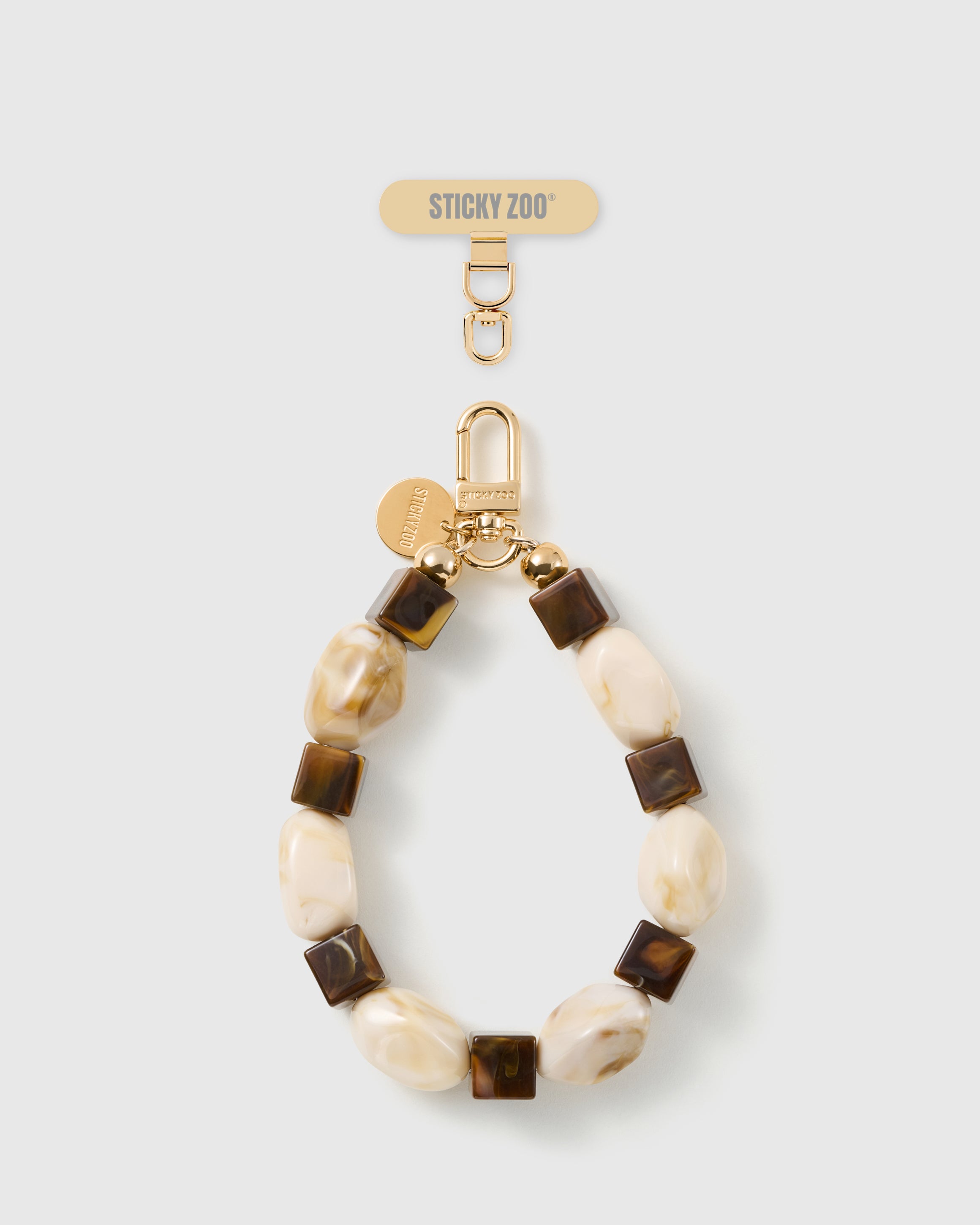 Handmade cocoa marbled bead phone strap by STICKYZOO with 18K gold-plated engraved hardware