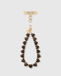 STICKYZOO Tortoiseshell Heart phone strap: full strand of amber-and-cocoa marbled heart beads with gold-tone hook, engraved disc and strap card.