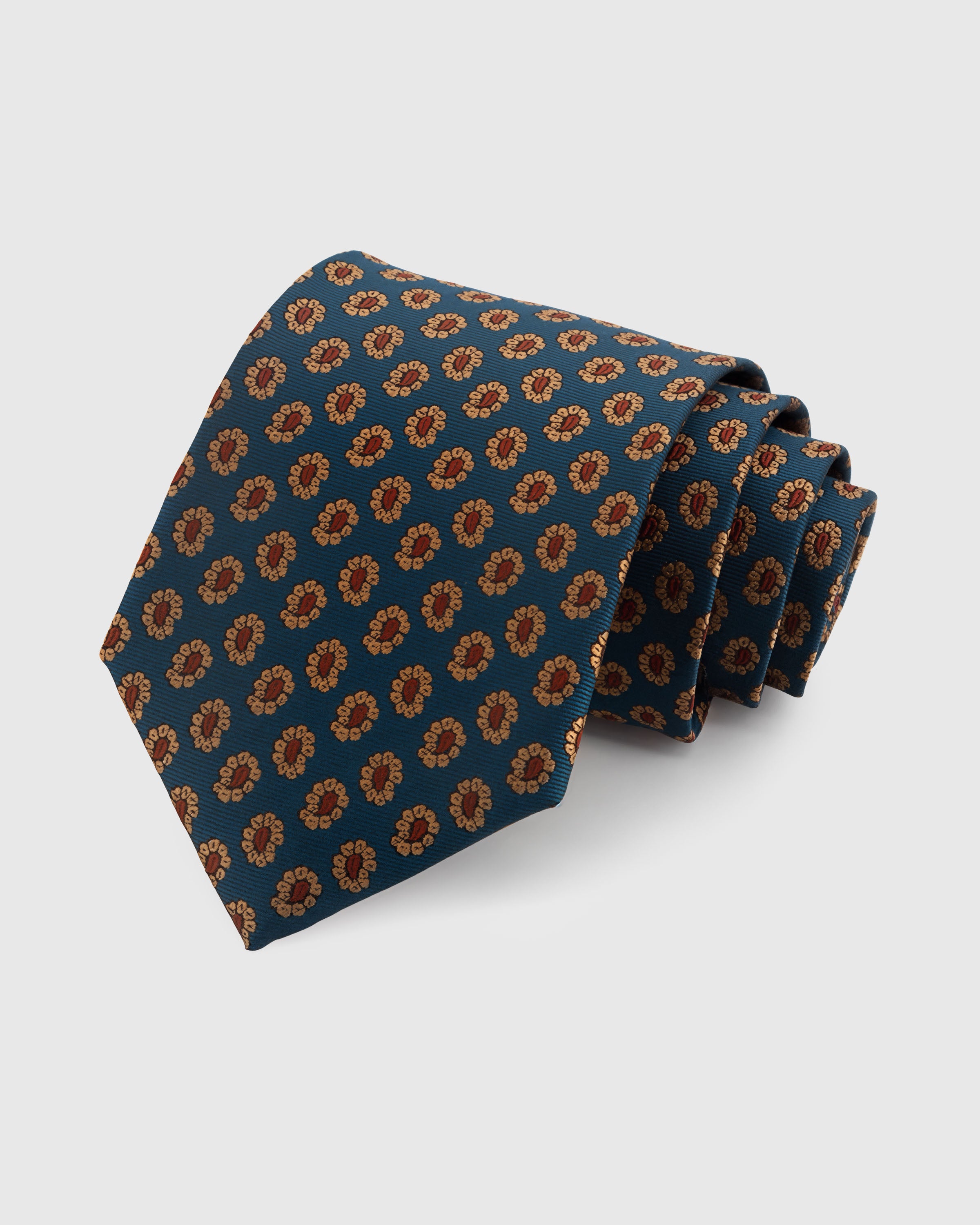 STICKYZOO TEAL FOULARD TIE — 100% mulberry silk with hand-embroidered amber and terracotta petal foulard motifs on deep teal blue ground