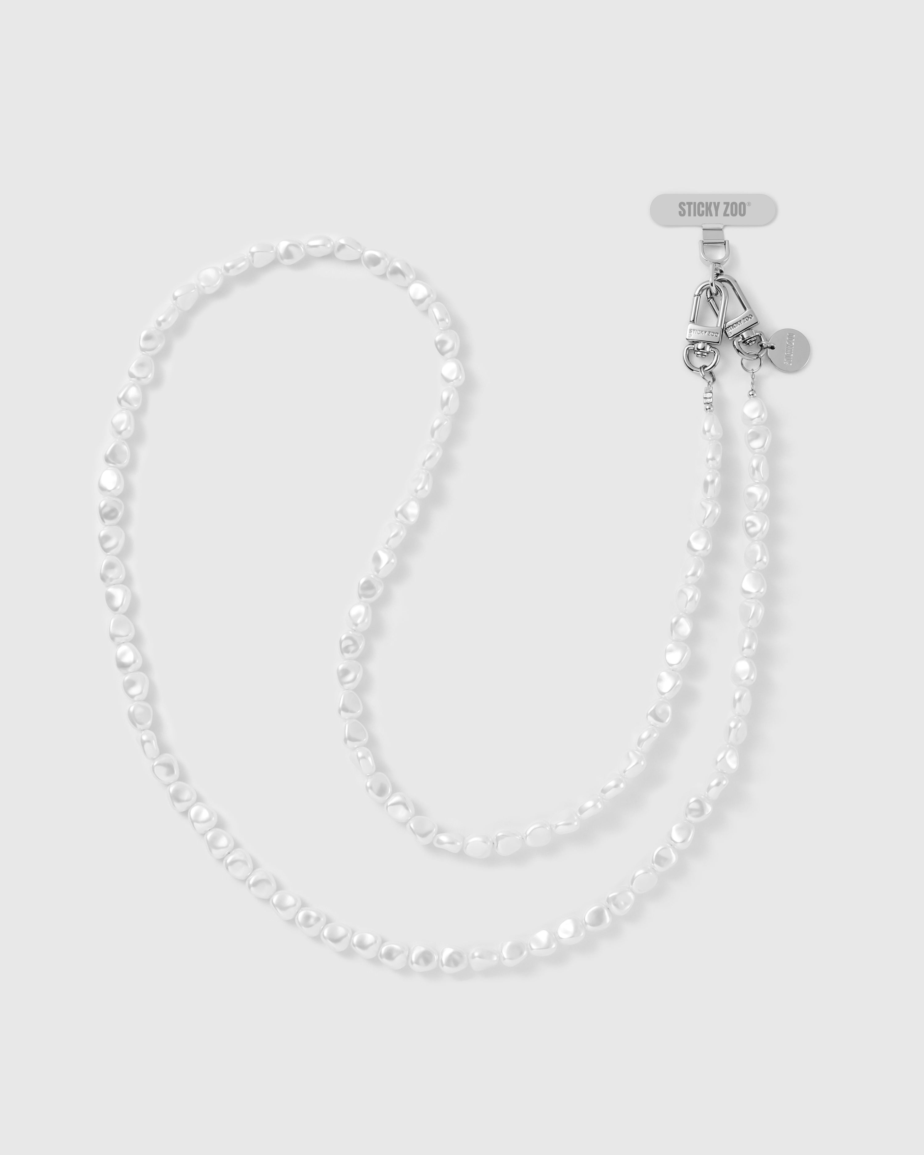 STICKYZOO cross-body phone strap in irregular white faux-pearl beads, doubled to show full length, with silver-tone dual clasps and engraved disc.