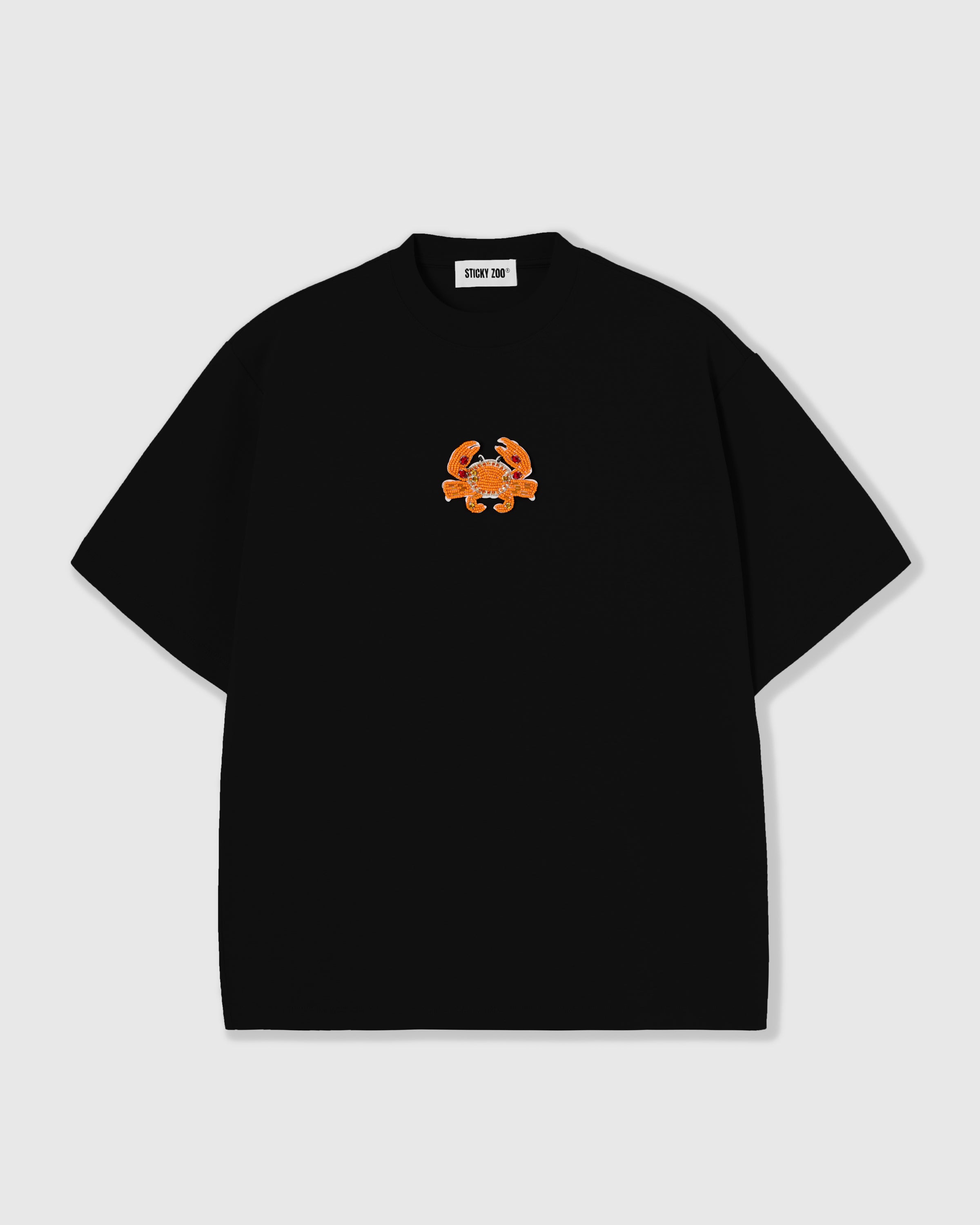 STICKYZOO Crab T-Shirt in black, oversized boxy 230gsm cotton tee with a hand-beaded orange crab and crystal accents centered on the chest