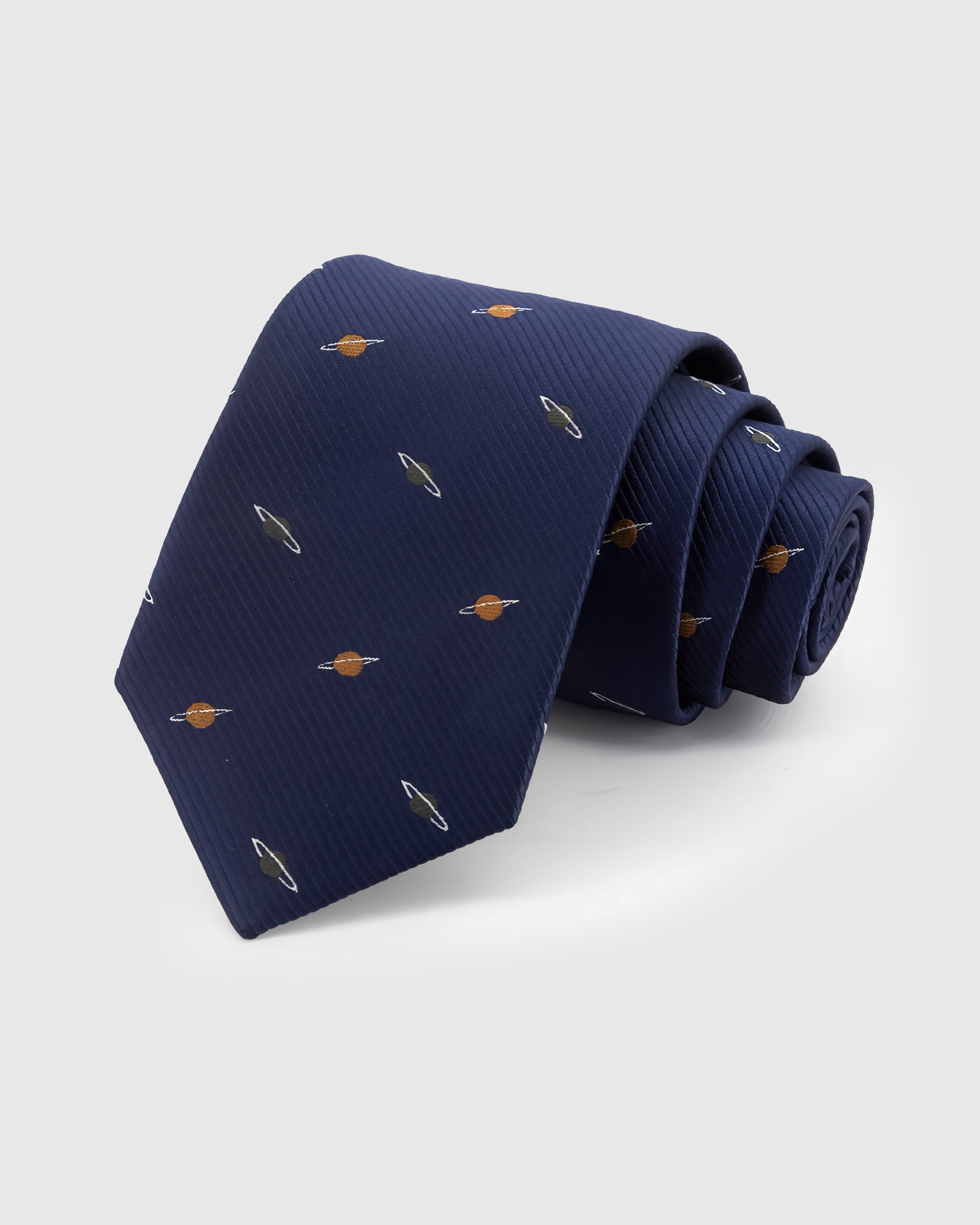 STICKYZOO Navy Saturn Tie in hand-embroidered mulberry silk with copper and olive Saturn motifs on deep navy ground, 45° bias-cut