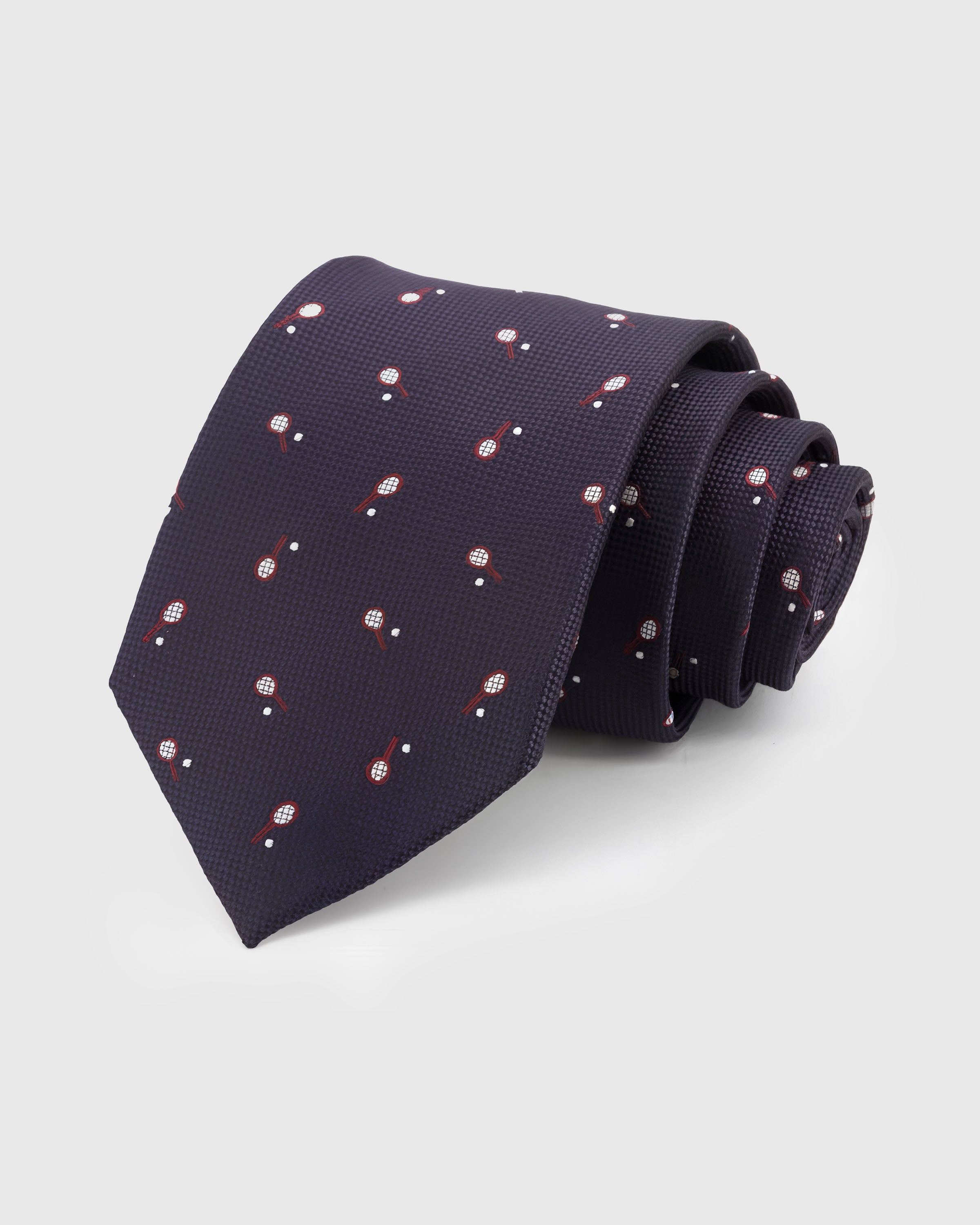 PLUM RACQUET TIE — Hand-embroidered tennis racquet detail on 100% mulberry silk in plum, showing embroidery texture and silk sheen