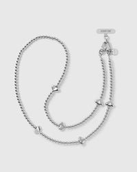 STICKYZOO silver-tone crossbody phone strap laid in a loop, ball-bead chain scattered with puffy heart beads and a dual clasp with engraved tab.
