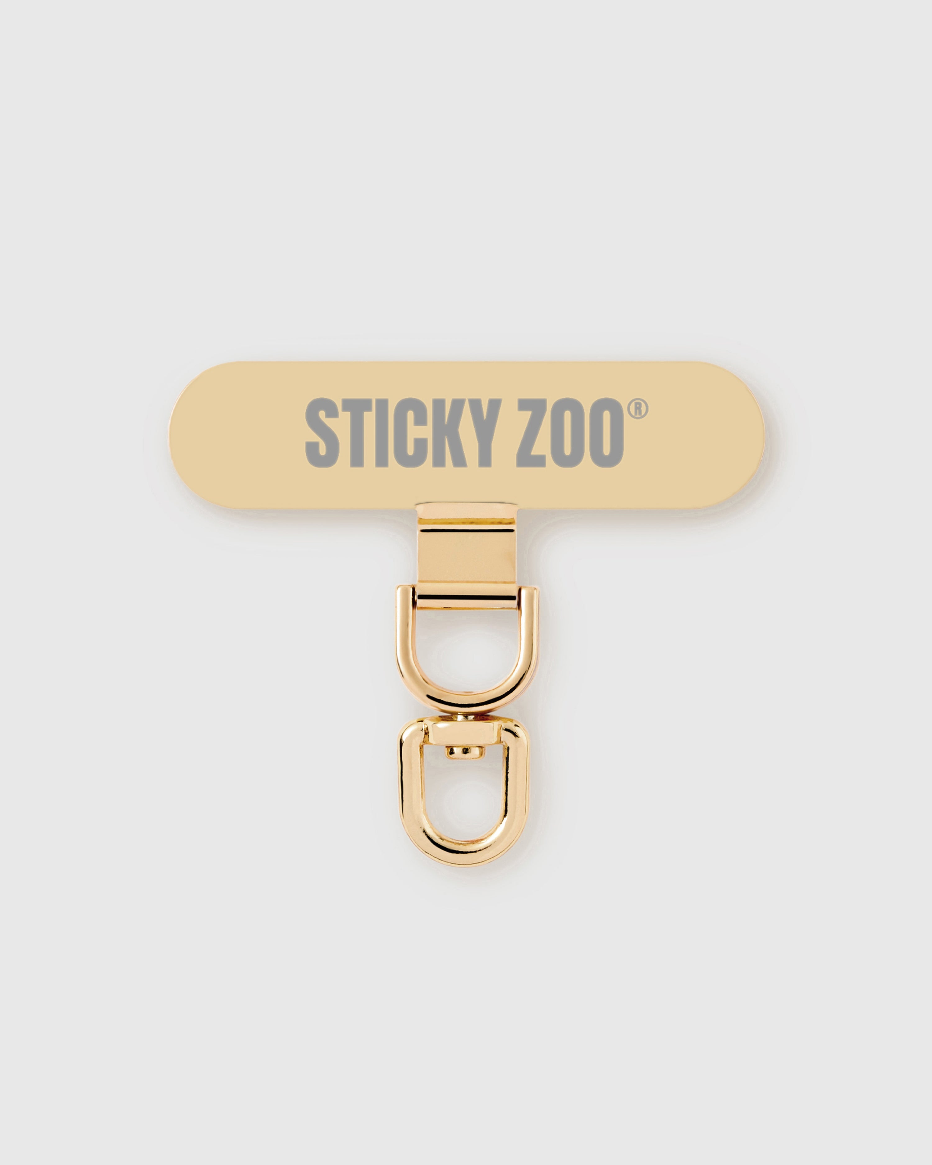 STICKYZOO Phone Strap Card — slim universal connector tab with a gold-tone swivel clasp that clips any phone strap to any phone.