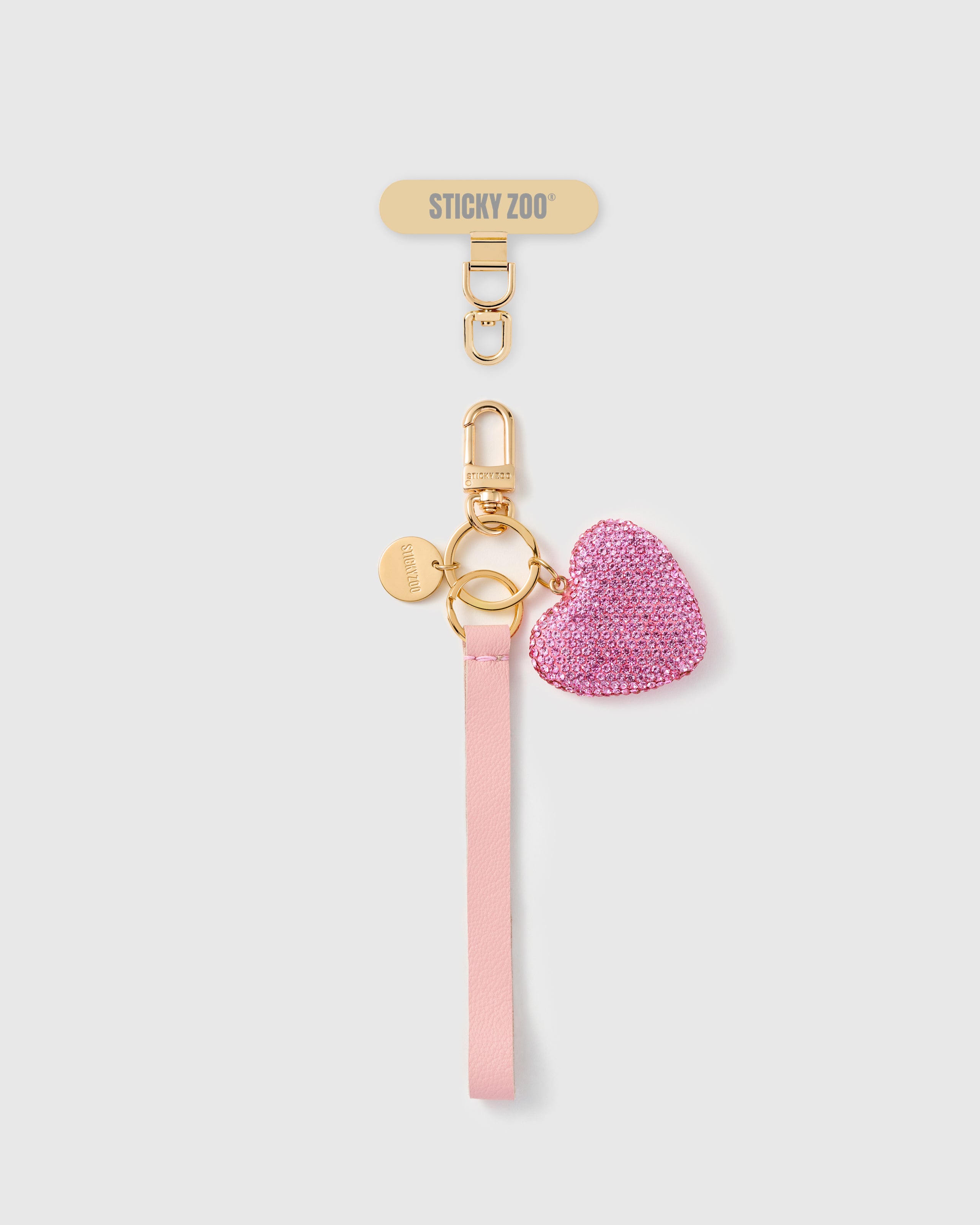 Handmade French Alran pale pink leather phone strap with hot pink crystal-pavé heart charm and 18K gold STICKYZOO hardware