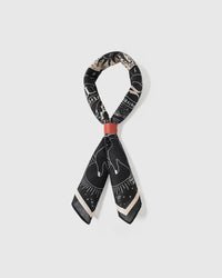 STICKYZOO zodiac wheel silk scarf looped through a scarf ring showing the celestial print and silk drape